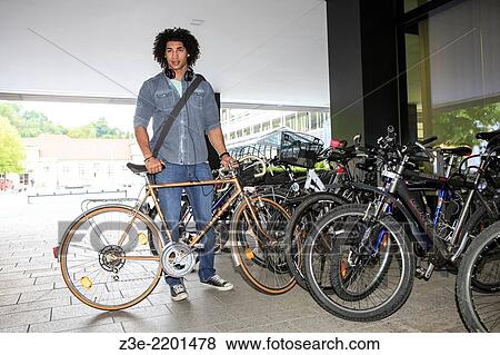 portrait of young male student with a bicycle in the town. View Large Photo Image Stock Photo - portrait of young male student with a bicycle in the town.. Fotosearch