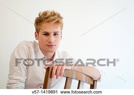 Stock Image - Portrait of young man looking at the camera. Fotosearch