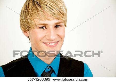 Stock Photography - Portrait of young man smiling and looking at the camera. Close view.. Fotosearch