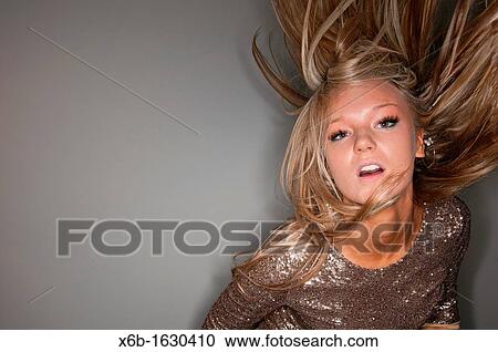 Portrait of young woman, 18-25 years, dancing and partying with hair flying in air View Large Photo Image Stock Image - Portrait of young woman, 18-25 years, dancing and partying with hair flying in air. Fotosearch
