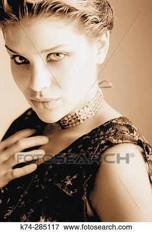 Stock Photo - Portrait of Young Woman Gazing At Camera. Fotosearch