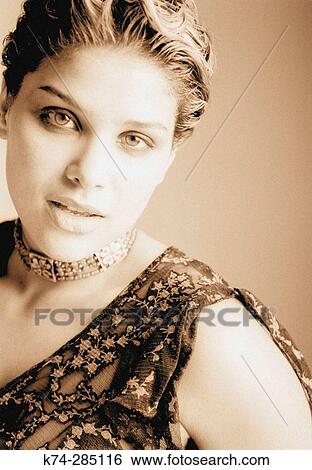 Stock Photograph - Portrait of Young Woman Gazing At Camera. Fotosearch