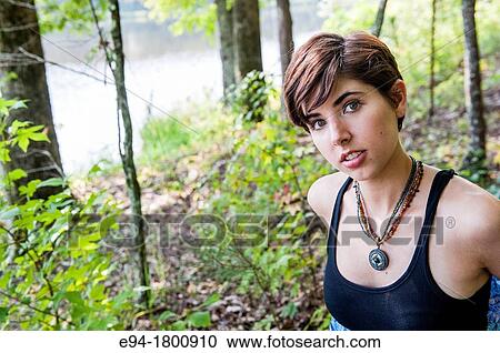 Portrait of young woman in a forest setting View Large Photo Image Stock Image - Portrait of young woman in a forest setting. Fotosearch