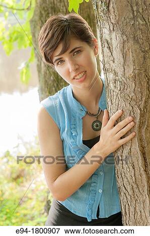 Portrait of young woman in a forest setting View Large Photo Image Stock Photo - Portrait of young woman in a forest setting. Fotosearch