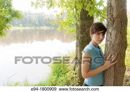 Portrait of young woman in a forest setting View Large Photo Image Stock Photo - Portrait of young woman in a forest setting. Fotosearch