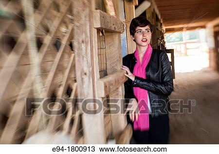 Portrait of young woman in a horse barn View Large Photo Image Stock Image - Portrait of young woman in a horse barn. Fotosearch