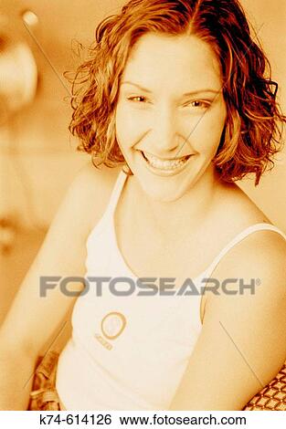 Portrait of Young Woman In Tank-Top Smiling At Camera View Large Photo Image Stock Photograph - Portrait of Young Woman In Tank-Top Smiling At Camera. Fotosearch
