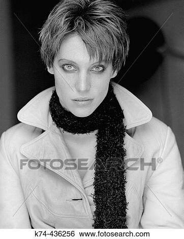 Portrait of young woman in trench coat and scarf View Large Photo Image Stock Photograph - Portrait of young woman in trench coat and scarf. Fotosearch