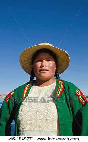 Portrait of young woman in Uros family on floating islands of Lake Titicaca in Puno Peru View Large Photo Image Stock Image - Portrait of young woman in Uros family on floating islands of Lake Titicaca in Puno Peru. Fotosearch