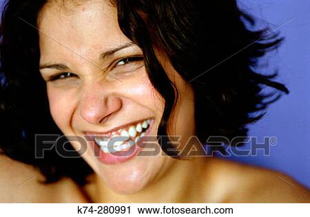 Stock Image - Portrait of Young Woman Laughing. Fotosearch