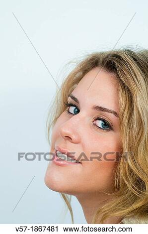 Stock Image - Portrait of young woman looking at the camera. Close view.. Fotosearch