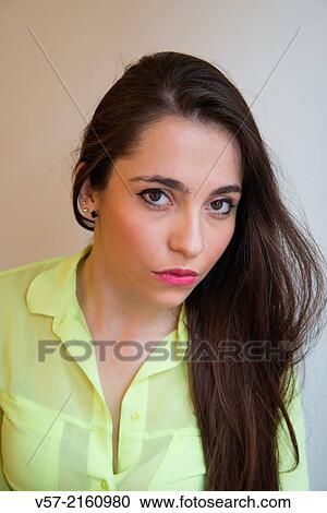 Portrait of young woman looking at the camera. View Large Photo Image Stock Image - Portrait of young woman looking at the camera.. Fotosearch