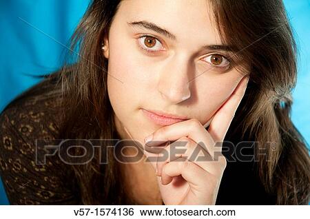 Portrait of young woman looking at the camera. Close view. View Large Photo Image Stock Photograph - Portrait of young woman looking at the camera. Close view.. Fotosearch