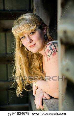 Portrait of young woman looking through barn window - Cedar Mountain, North Carolina, USA View Large Photo Image Stock Photo - Portrait of young woman looking through barn window - Cedar Mountain, North Carolina, USA. Fotosearch