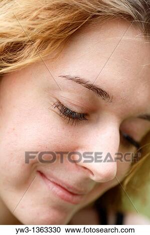 Stock Image - Portrait of young woman outdoors. Fotosearch