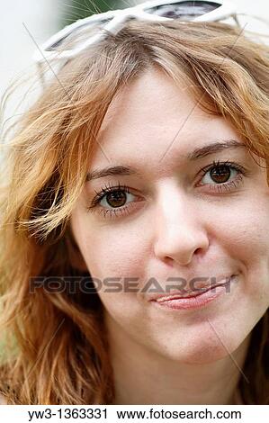 Stock Image - Portrait of young woman outdoors. Fotosearch