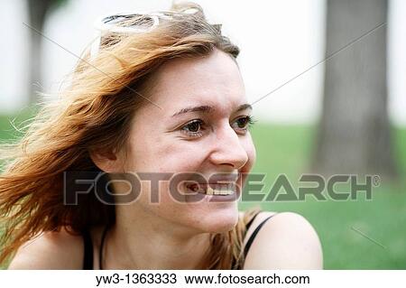 Stock Image - Portrait of young woman outdoors. Fotosearch
