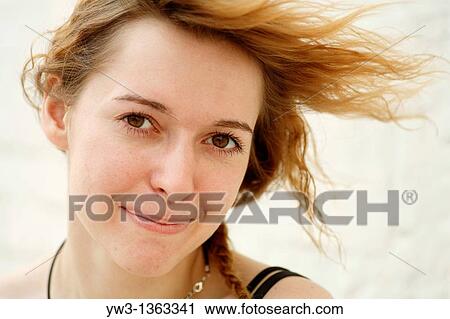 Stock Image - Portrait of young woman outdoors. Fotosearch