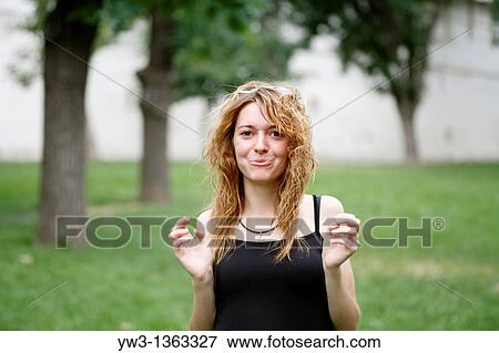 Stock Photo - Portrait of young woman outdoors. Fotosearch