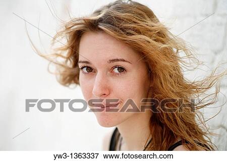 Stock Photo - Portrait of young woman outdoors. Fotosearch