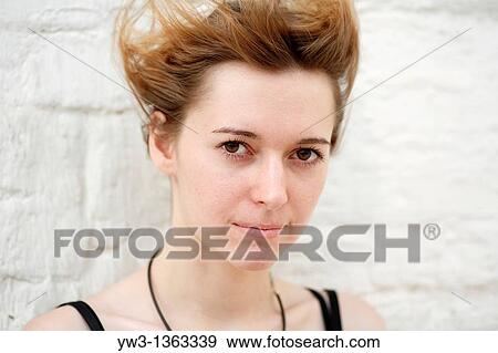 Stock Photo - Portrait of young woman outdoors. Fotosearch