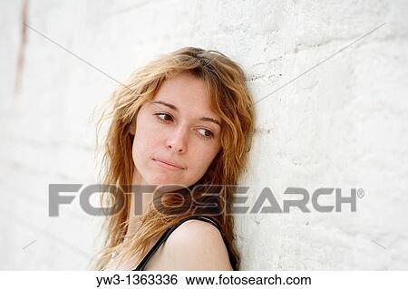 Stock Photograph - Portrait of young woman outdoors. Fotosearch