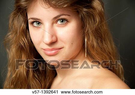 Portrait of young woman smiling and looking at the camera. Close view. View Large Photo Image Stock Image - Portrait of young woman smiling and looking at the camera. Close view.. Fotosearch