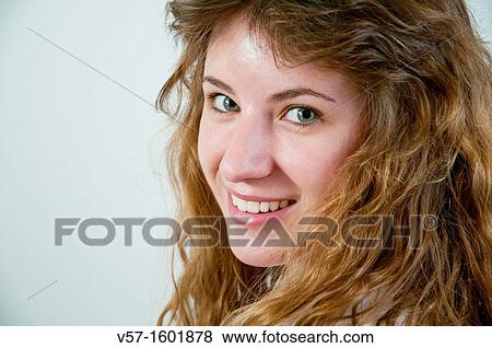Portrait of young woman smiling and looking at the camera. Close view. View Large Photo Image Stock Photo - Portrait of young woman smiling and looking at the camera. Close view.. Fotosearch