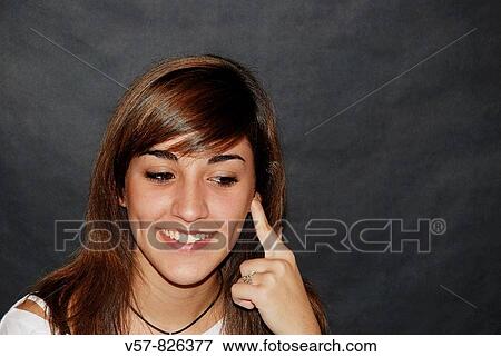 Portrait of young woman smiling and looking down View Large Photo Image Stock Photo - Portrait of young woman smiling and looking down. Fotosearch
