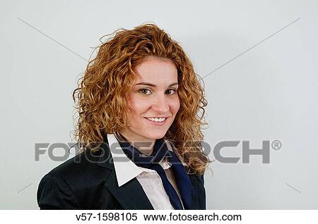 Stock Photography - Portrait of young woman smiling and looking at the camera. Fotosearch