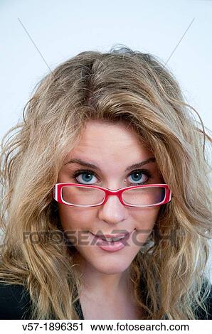 Portrait of young woman wearing spectacles, smiling and looking at the camera. Close view. View Large Photo Image Stock Image - Portrait of young woman wearing spectacles, smiling and looking at the camera. Close view.. Fotosearch