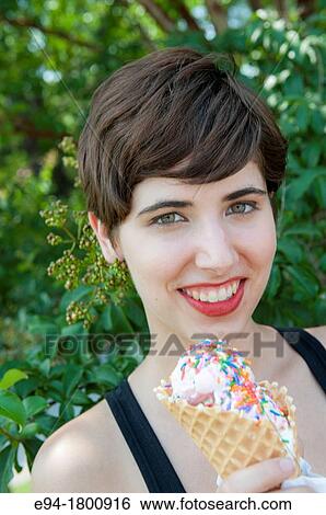 Portrait of young woman with an ice cream cone View Large Photo Image Stock Photograph - Portrait of young woman with an ice cream cone. Fotosearch