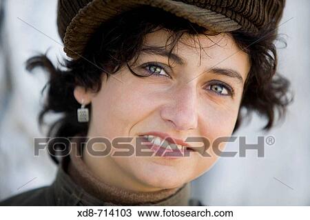 Portrait of young woman with blue eyes and a velveteen cap smiling View Large Photo Image Stock Image - Portrait of young woman with blue eyes and a velveteen cap smiling. Fotosearch