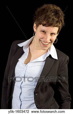 Stock Image - Portrait with black background of Corianne, a happy freelancer, made in Studio Tuinstraat, Tilburg.. Fotosearch
