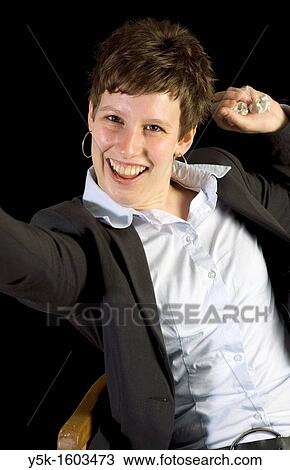 Stock Image - Portrait with black background of Corianne, a happy freelancer, made in Studio Tuinstraat, Tilburg.. Fotosearch
