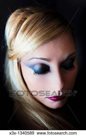 Portrait woman model with makeup looking down View Large Photo Image Stock Photo - Portrait woman model with makeup looking down. Fotosearch