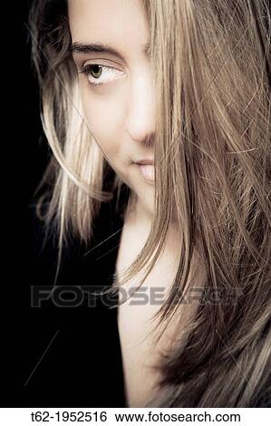 Stock Photograph - Portrait young woman with blond long hair.. Fotosearch