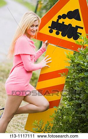 Posing by the railway sign View Large Photo Image Stock Image - Posing by the railway sign. Fotosearch