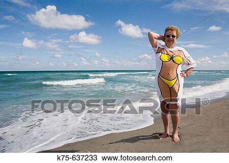 Stock Image - Posing for photo wearing fun tee shirt. Fotosearch