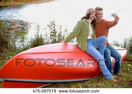 Posing for the digital camera on the canoe View Large Photo Image Stock Photo - Posing for the digital camera on the canoe. Fotosearch