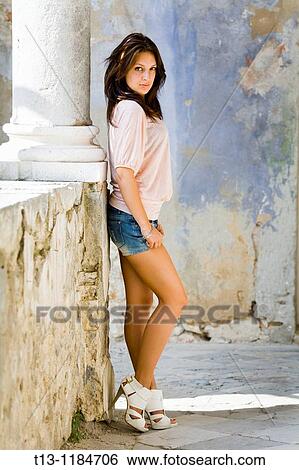 Posing in an empty corridor young woman View Large Photo Image Stock Photograph - Posing in an empty corridor young woman. Fotosearch