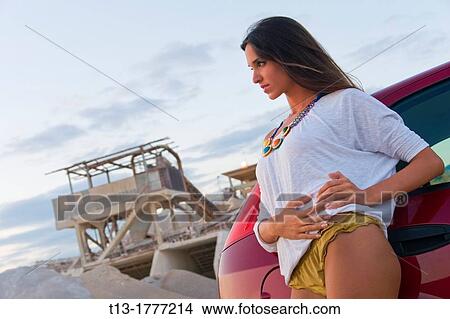 Posing in industrial environment next to a car young woman View Large Photo Image Picture - Posing in industrial environment next to a car young woman. Fotosearch