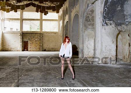 Stock Image - Posing in old empty warehouse sexy woman. Fotosearch