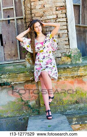 Posing next to a derelict house young lady View Large Photo Image Stock Photo - Posing next to a derelict house young lady. Fotosearch