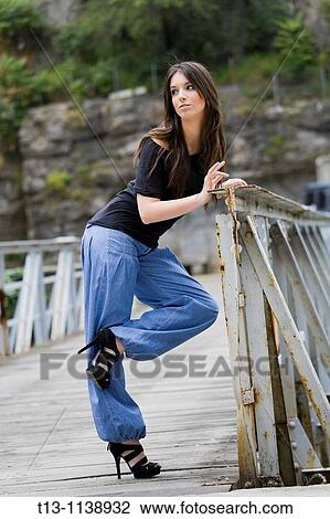 Posing on a footbridge young woman View Large Photo Image Stock Image - Posing on a footbridge young woman. Fotosearch