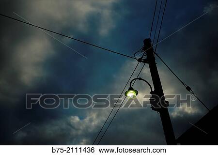Post with electric wires and a street lamp lit at sunset. Yorkshire Dales, England, UK, Europe. View Large Photo Image Stock Photograph - Post with electric wires and a street lamp lit at sunset. Yorkshire Dales, England, UK, Europe.. Fotosearch