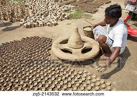 Potter making lamps on a traditional wheel with special clay. Kumhartoli village, District Ranchi, Jharkhand, India. View Large Photo Image Stock Image - Potter making lamps on a traditional wheel with special clay. Kumhartoli village, District Ranchi, Jharkhand, India.. Fotosearch