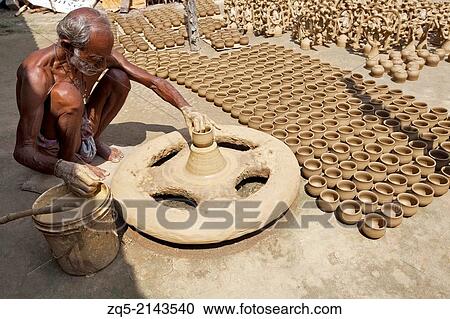 Potter making pots on a traditional wheel with special clay. Kumhartoli village, District Ranchi, Jharkhand, India. View Large Photo Image Stock Image - Potter making pots on a traditional wheel with special clay. Kumhartoli village, District Ranchi, Jharkhand, India.. Fotosearch