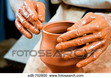 Potter working in a clay pot View Large Photo Image Stock Image - Potter working in a clay pot. Fotosearch
