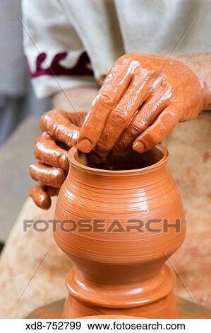 Potter working in a clay pot View Large Photo Image Stock Photo - Potter working in a clay pot. Fotosearch